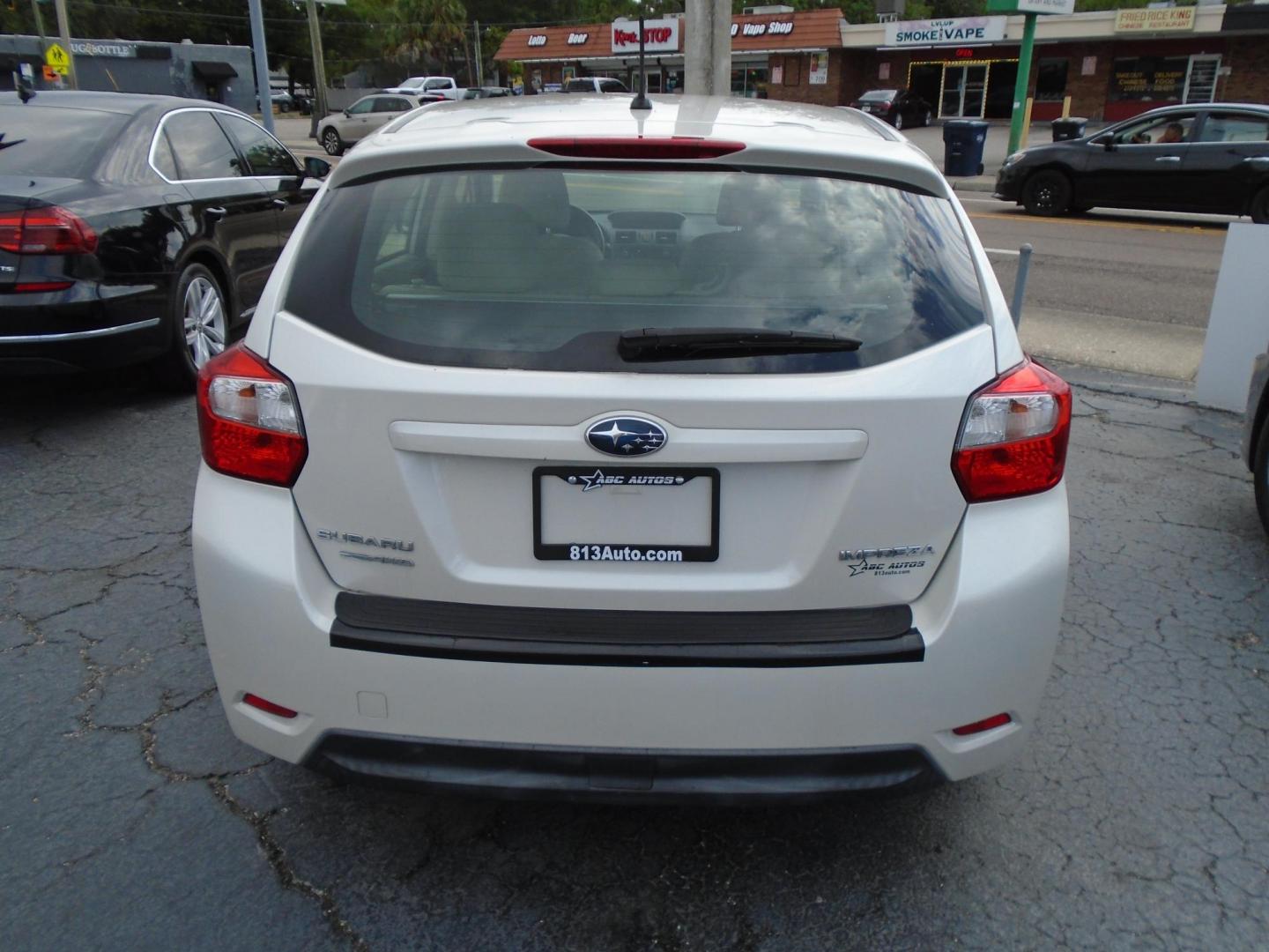 2012 Subaru Impreza Limited 5-Door (JF1GPAG64CH) with an 2.0L H4 DOHC 16V engine, Continuously Variable Transmission transmission, located at 6112 N Florida Avenue, Tampa, FL, 33604, (888) 521-5131, 27.954929, -82.459534 - Photo#2
