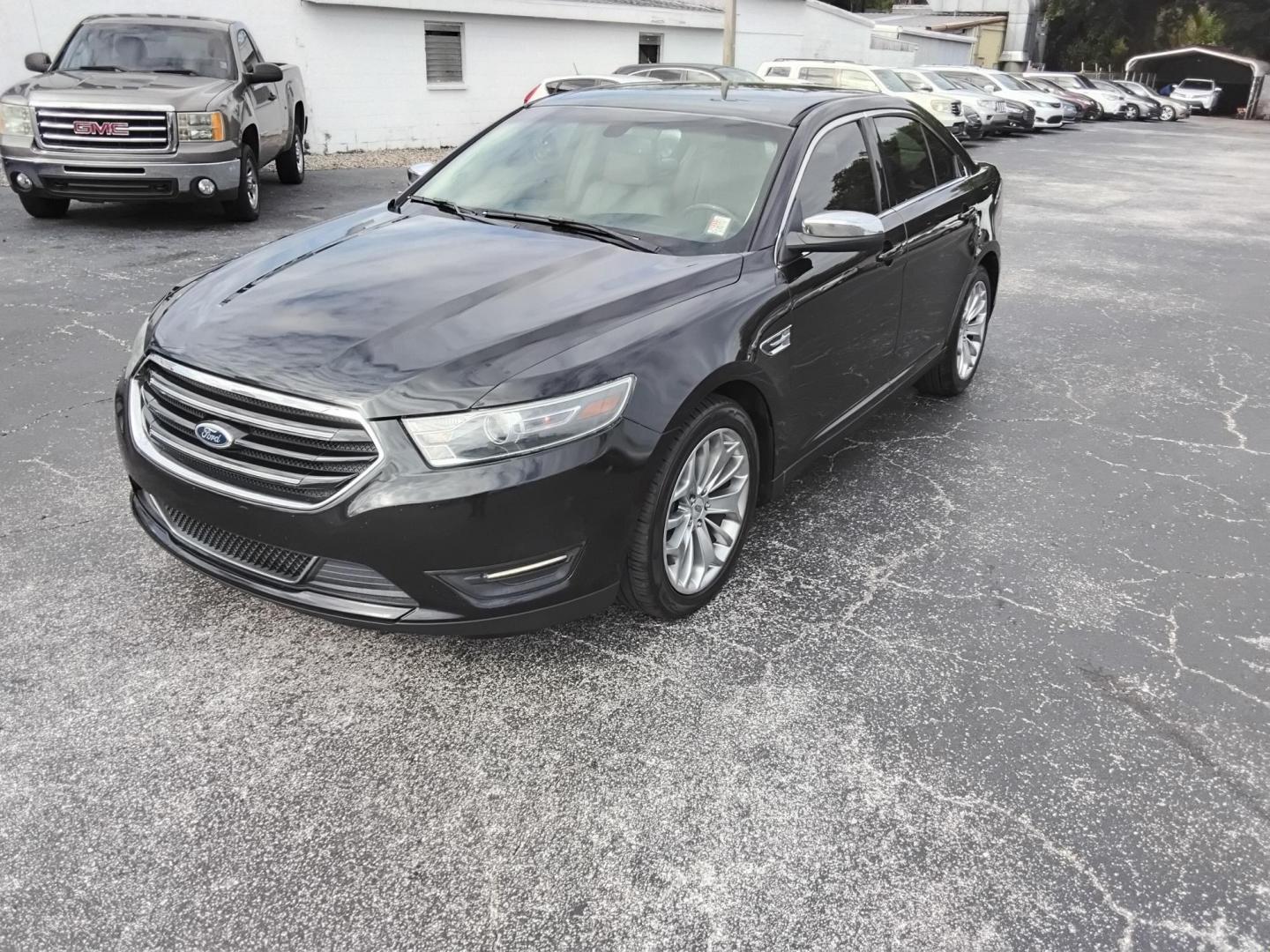 2015 BLACK /Beige Ford Taurus Limited FWD (1FAHP2F80FG) with an 3.5L V6 DOHC 24V engine, 6-Speed Automatic transmission, located at 6112 N Florida Avenue, Tampa, FL, 33604, (888) 521-5131, 27.954929, -82.459534 - $499 DOWN PLUS TAX & TAG. - Photo#1