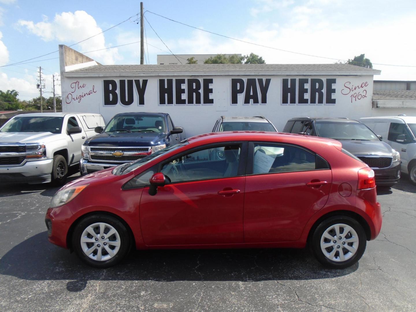 2014 Red Kia Rio LX (KNADM5A32E6) with an 4-Cyl, 1.6 Liter engine, Automatic, 6-Spd transmission, located at 6112 N Florida Avenue, Tampa, FL, 33604, (888) 521-5131, 27.954929, -82.459534 - Photo#0